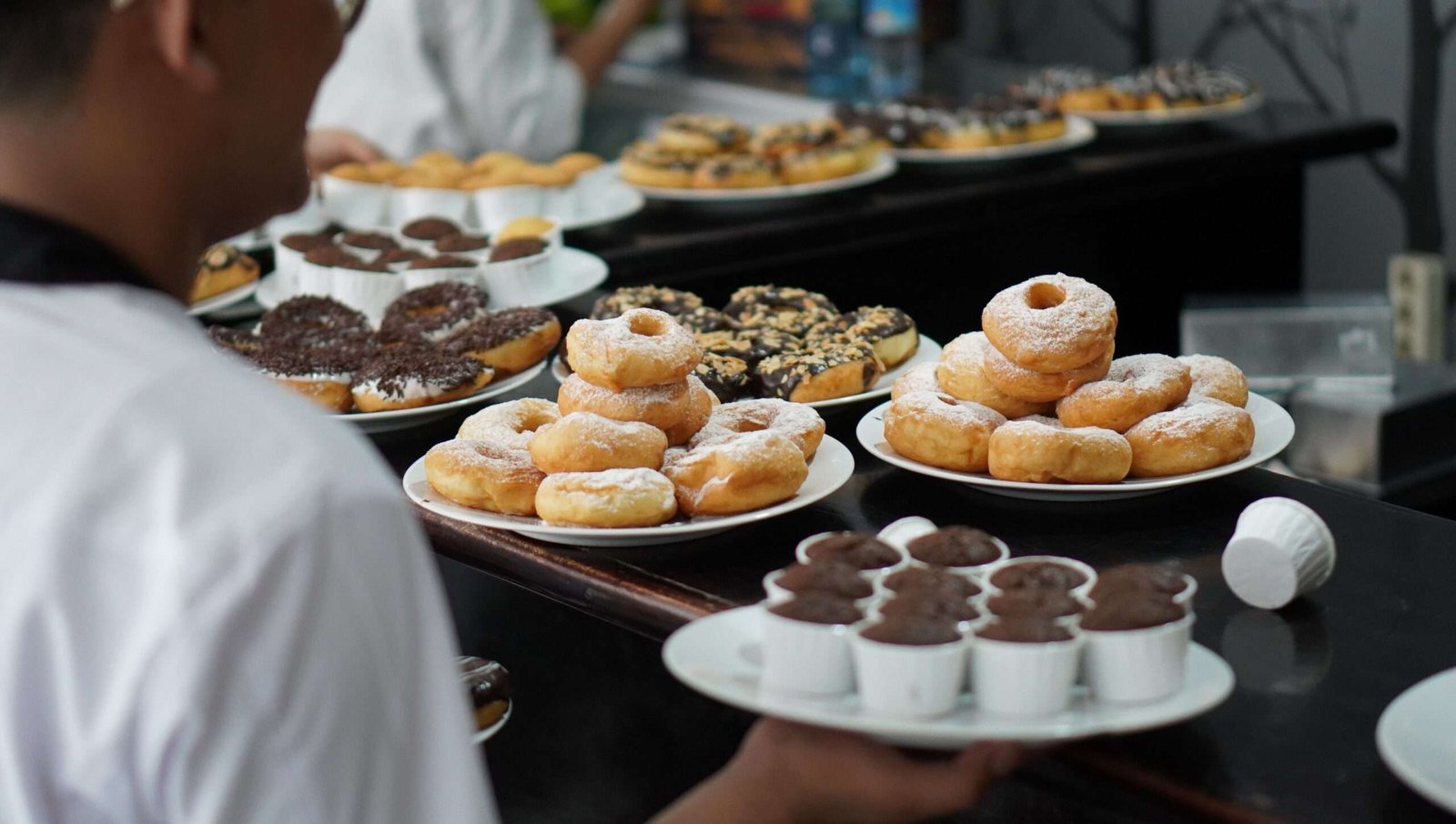 Assorted donuts and chocolate desserts showcased on a buffet in Nusa Tenggara, Indonesia.