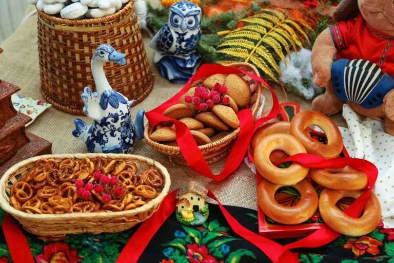 Colorful arrangement of Russian pastries and ceramics with a festive display of bagels and stuffed animals.